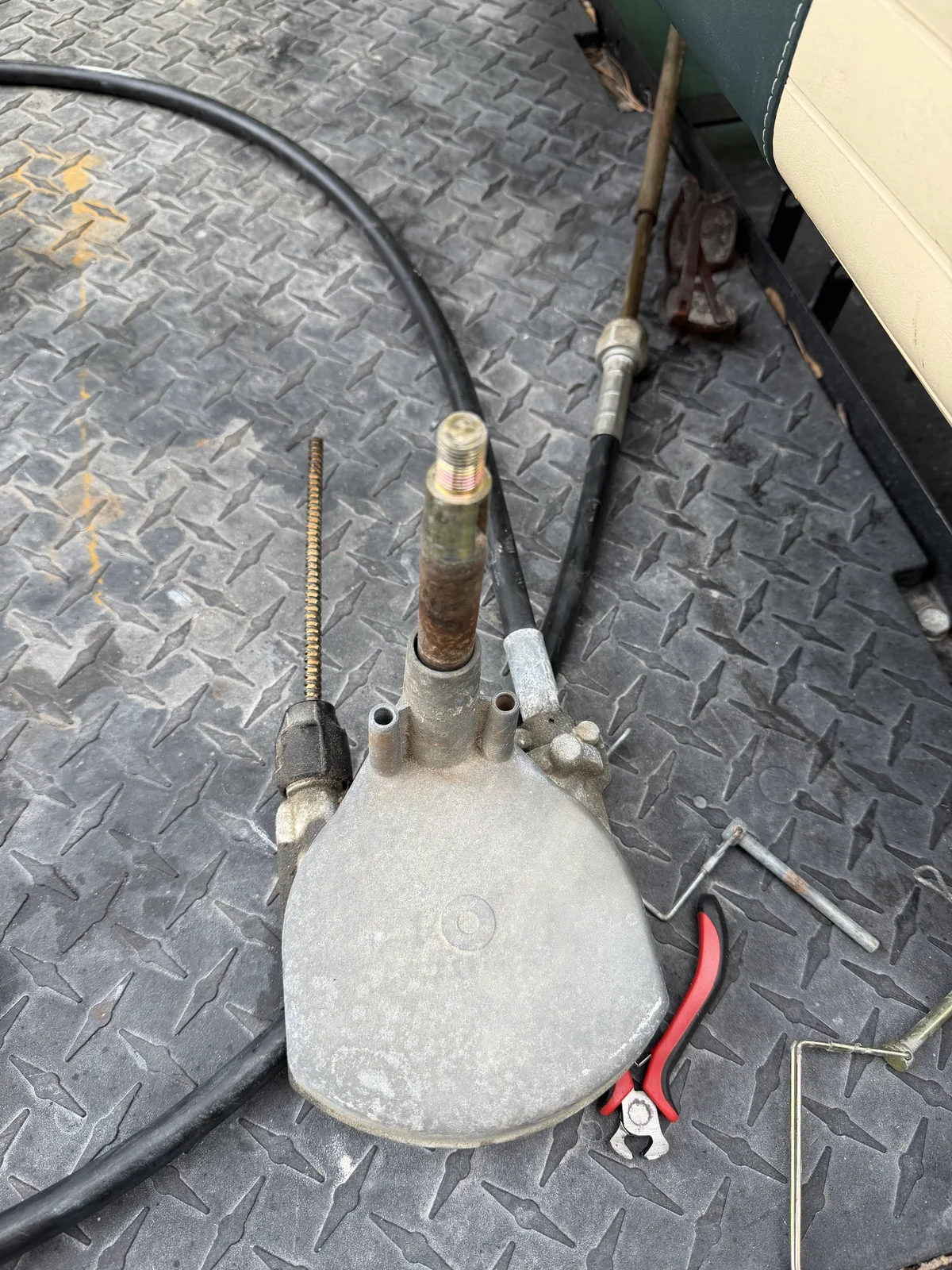 The old cable steering rack pulled from the J16, cable run coiled off to the side